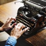 negative-space-vintage-desk-typewriter-man-hands-rawpixel-thumb-1
